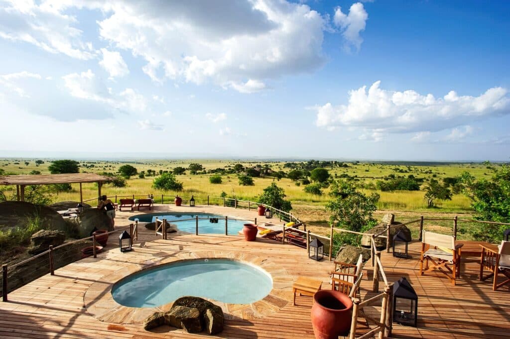 A pool with a pool and a blue sky with clouds at a hotel near the Kruger