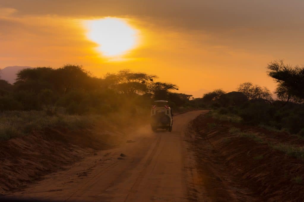 An offroad vehicle driving into the sunset for night safari Kruger experience