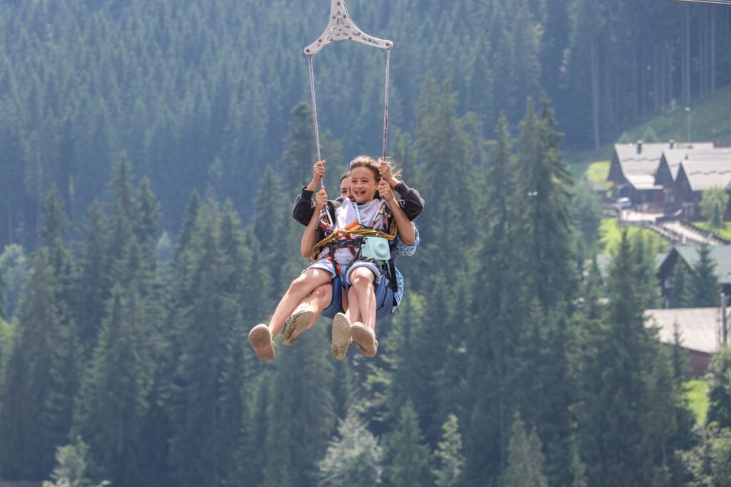 A child and parent ziplining over mountains for adventures in Mpumalanga