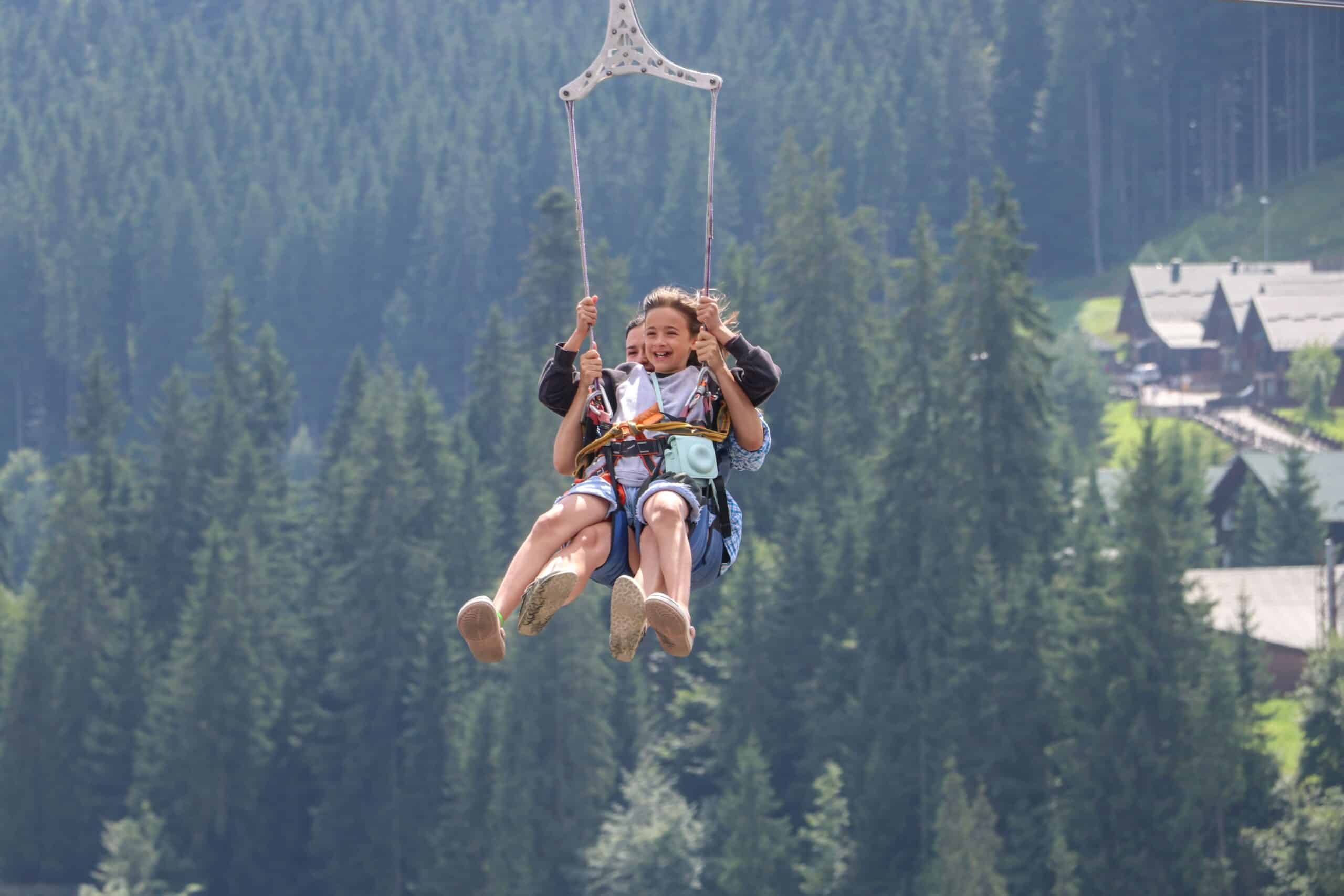 A child and parent ziplining over mountains for adventures in Mpumalanga