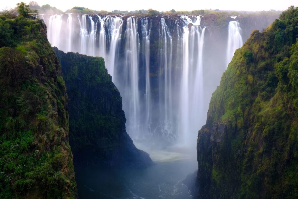 Waterfall Surrounded by trees and hills