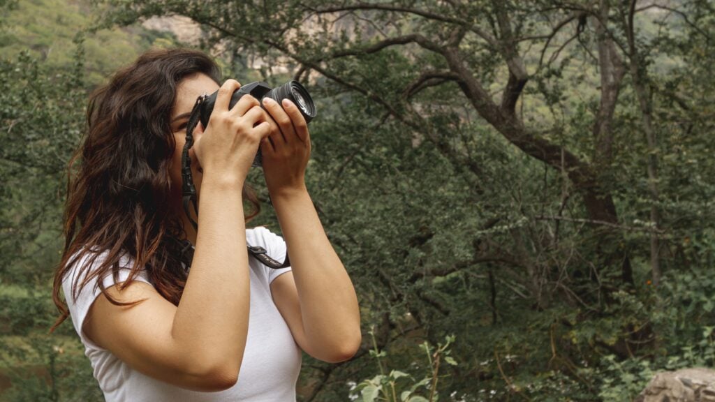 Side view woman taking photos of nature